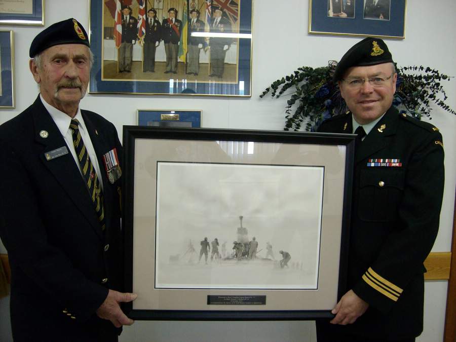 Major Haskell, CO of 64 Battery, 10th Field Regiment presenting President Wyatt with a framed picture depicting his Battery personnel in action in Afghanistan.
